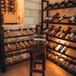 Explore a warm, inviting wine cellar with wooden racks and ambient lighting. Perfect for wine enthusiasts.